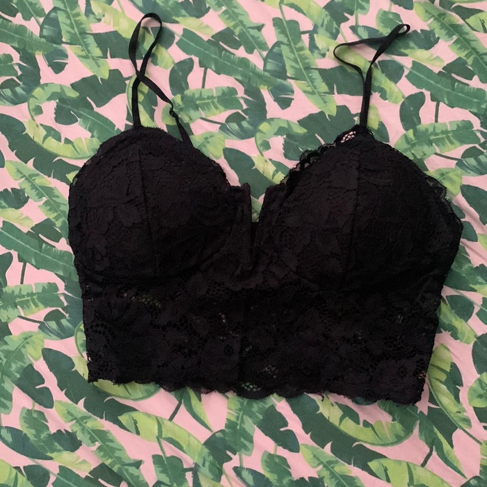 Black lace corset crop top with adjustable straps and padding.